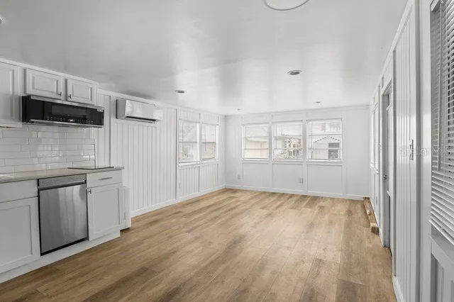 a view of a kitchen with dishwasher and a refrigerator