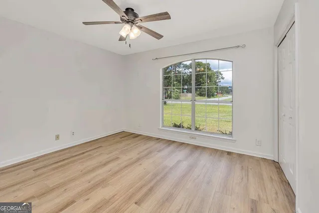 wooden floor in an empty room with a window
