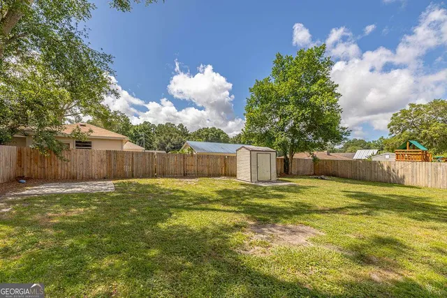 a bathroom with a small yard and large tree