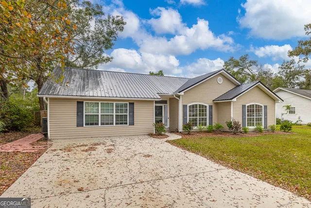 a front view of a house with yard