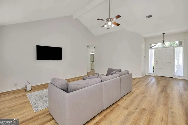 a living room with furniture and a flat screen tv