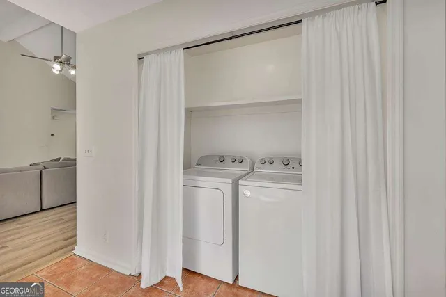 a view of washer and dryer with wooden floor