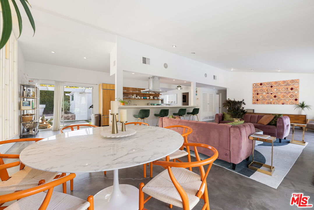 1155 East Mesquite Avenue Palm Springs, CA 92264 - Photo 11 of 32 a dining room with furniture a table and kitchen view