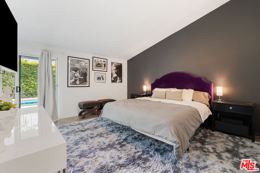 1155 East Mesquite Avenue Palm Springs, CA 92264 - Photo 15 of 32 a bedroom with a large bed and a large window