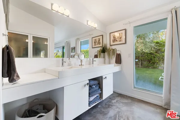 a bathroom with a double vanity sink and a mirror