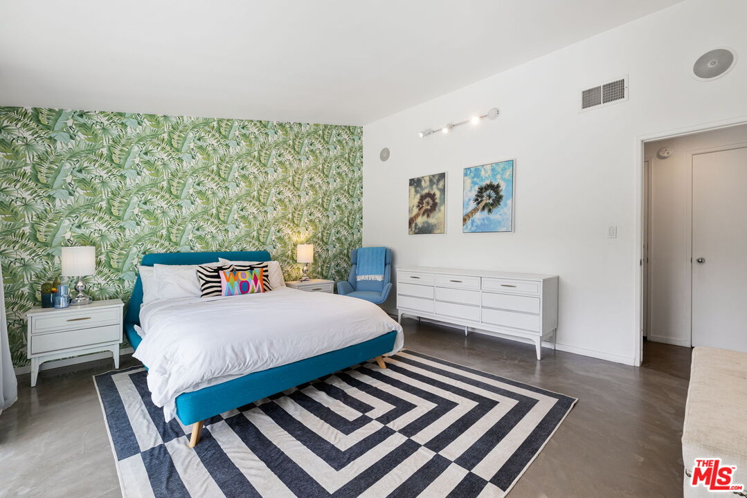 1155 East Mesquite Avenue Palm Springs, CA 92264 - Photo 21 of 32 a bedroom with a bed and a table in it