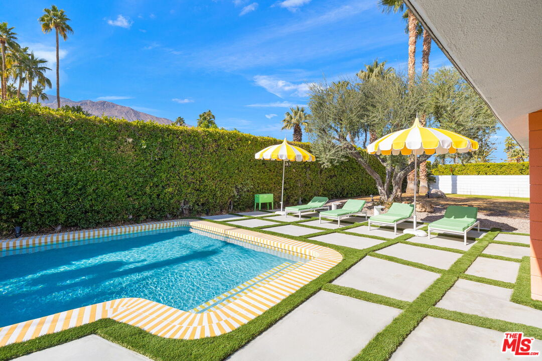 1155 East Mesquite Avenue Palm Springs, CA 92264 - Photo 27 of 32 a view of a swimming pool with a patio and a yard