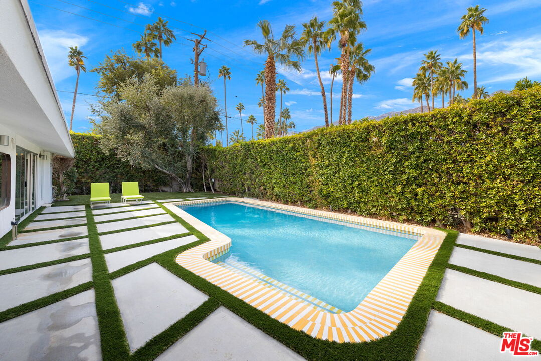1155 East Mesquite Avenue Palm Springs, CA 92264 - Photo 30 of 32 a view of a pool with a yard