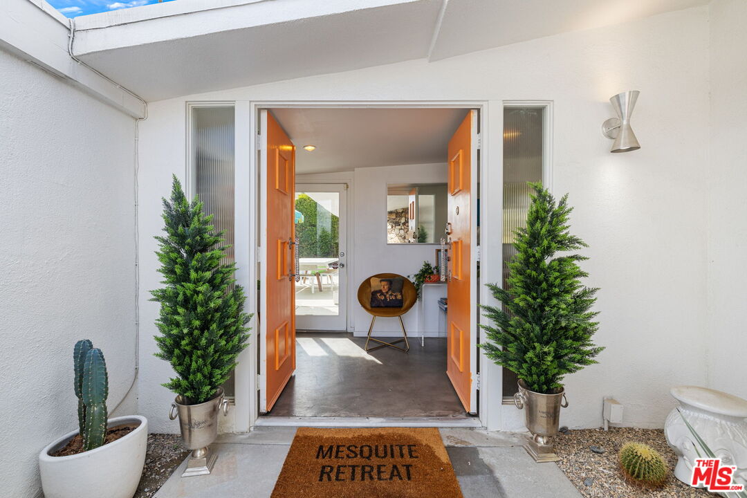 1155 East Mesquite Avenue Palm Springs, CA 92264 - Photo 3 of 32 view of living room filled with furniture and potted plant
