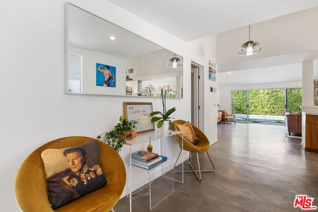 1155 East Mesquite Avenue Palm Springs, CA 92264 - Photo 4 of 32 a living room with furniture and a large window