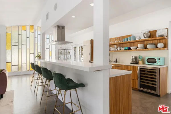 a dining room with furniture and a window