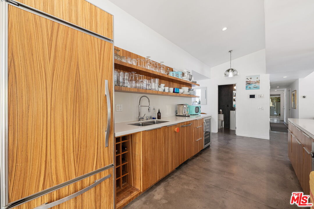 1155 East Mesquite Avenue Palm Springs, CA 92264 - Photo 9 of 32 a kitchen with stainless steel appliances granite countertop a sink and cabinets