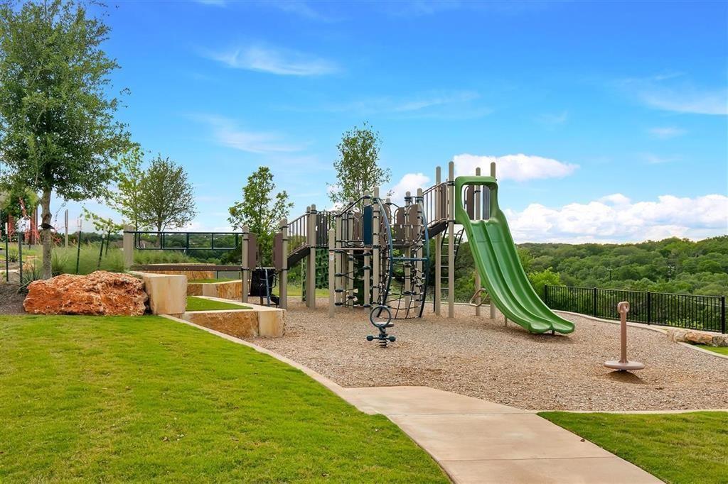 129 Starflower Cove Georgetown, TX 78628 - Photo 19 of 31 Community play area featuring a lawn