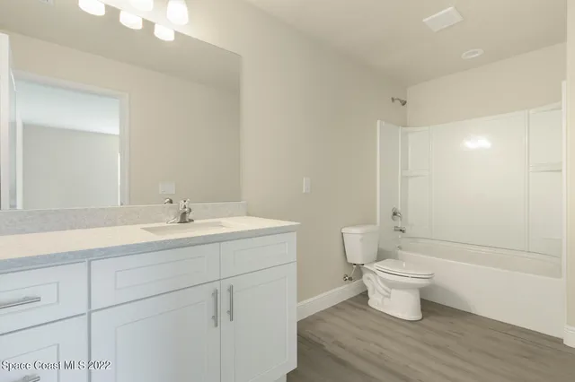 a bathroom with a double vanity sink mirror and