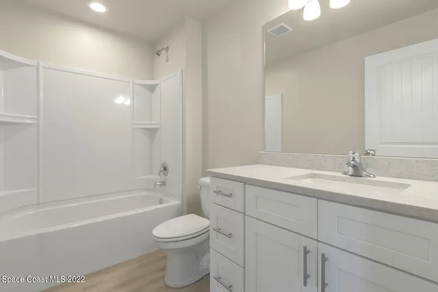 a view of an empty room and wooden floor