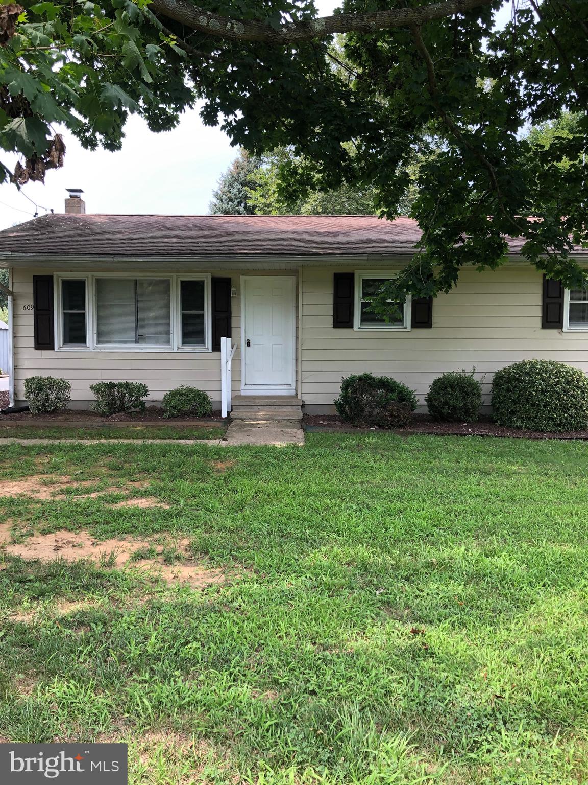609 Plain Dealing Road Magnolia, DE 19962 - Photo 2 of 9 a front view of a house with a garden and yard