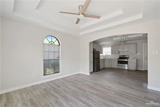 a view of a kitchen with wooden floor and a window