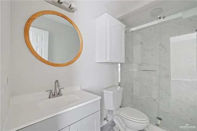 a bathroom with a sink a toilet and a mirror