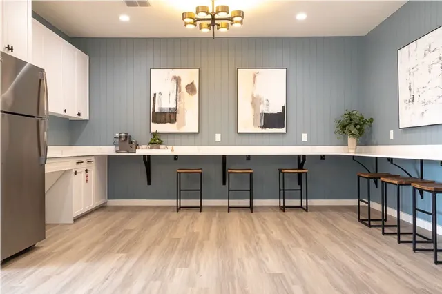 a living room with furniture and kitchen view