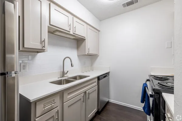 a kitchen with a sink and cabinets