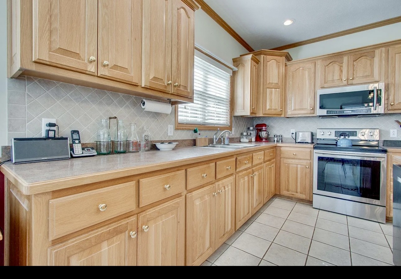 879 Tidwell Road Burns, TN 37029 - Photo 13 of 20 a kitchen with cabinets appliances a sink and a window