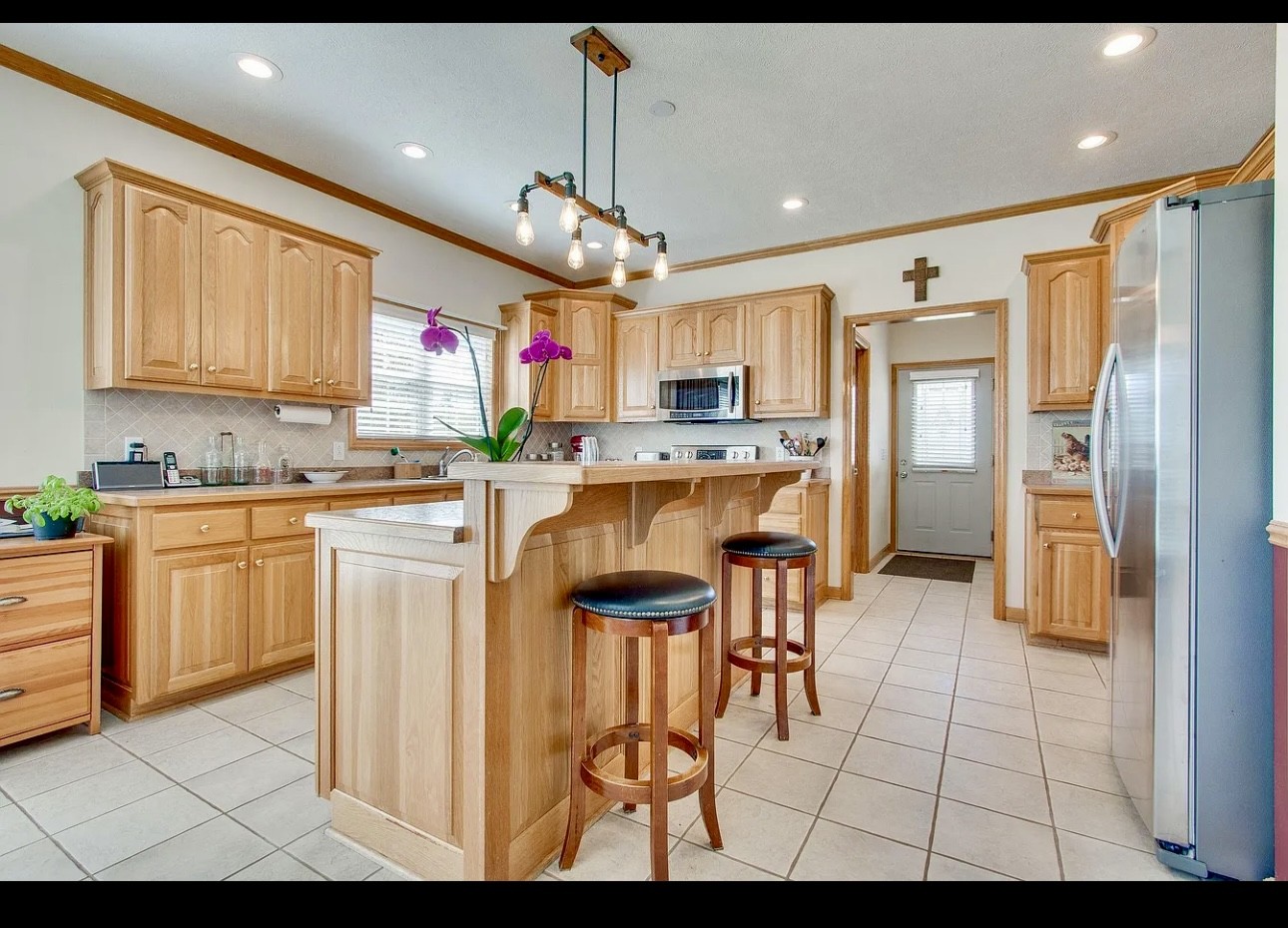 879 Tidwell Road Burns, TN 37029 - Photo 17 of 20 a kitchen with stainless steel appliances kitchen island granite countertop a refrigerator and microwave