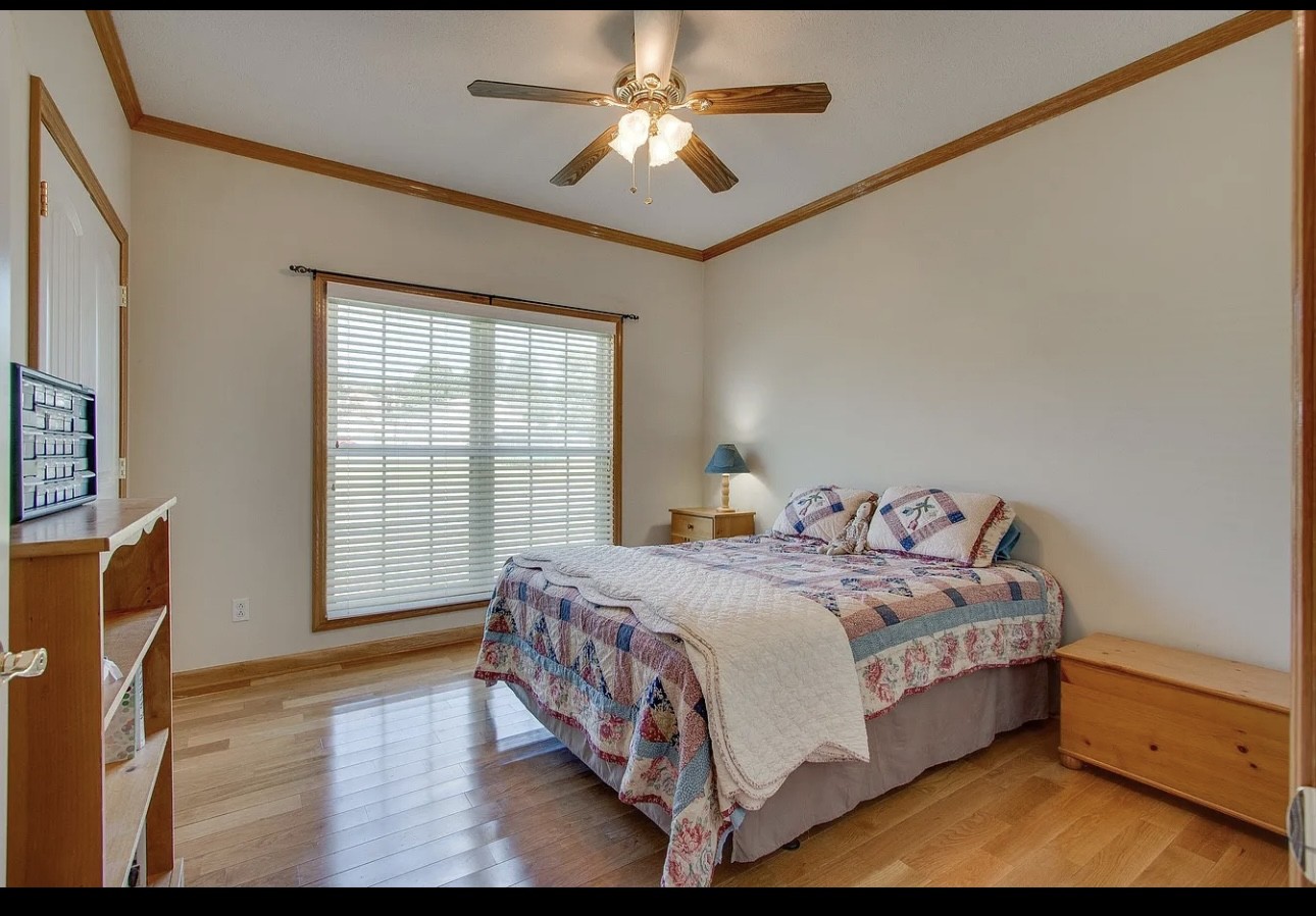 879 Tidwell Road Burns, TN 37029 - Photo 7 of 20 a bed sitting in a bedroom next to a window