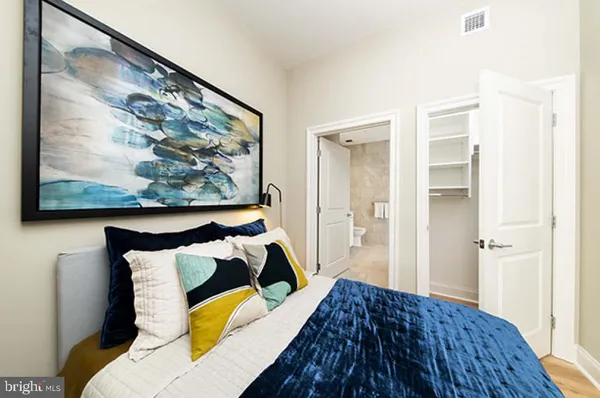 a bedroom with a bed and cupboard