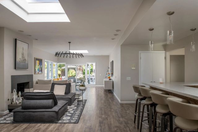 a living room with furniture a fireplace and a chandelier