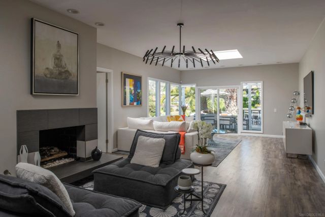a living room with furniture chandelier and a fireplace