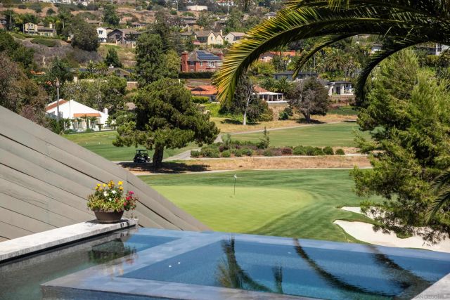 swimming pool view with a garden space