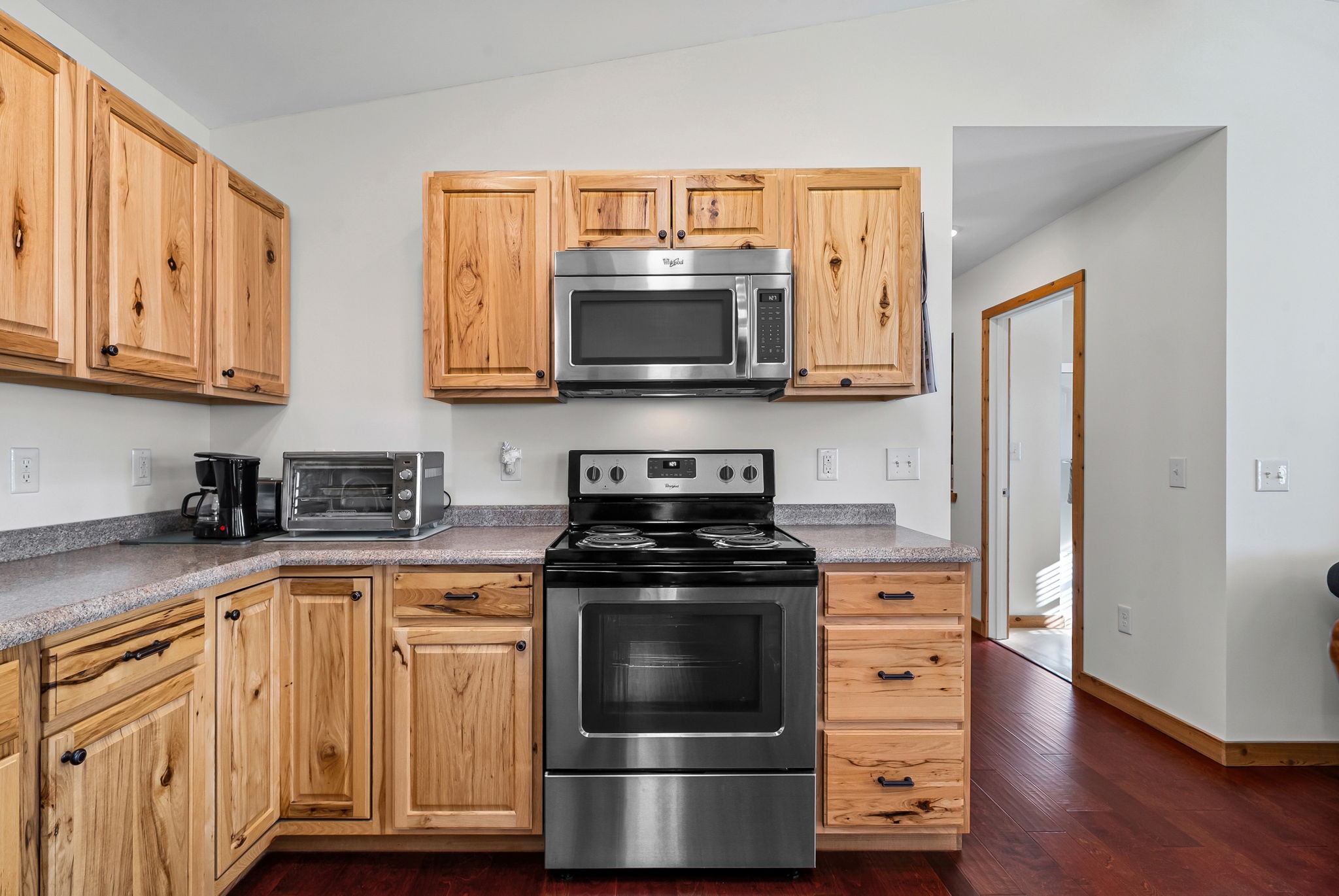959 Herman Adams Road Cumberland City, TN 37050 - Photo 12 of 62 a kitchen with stainless steel appliances granite countertop a stove and a microwave