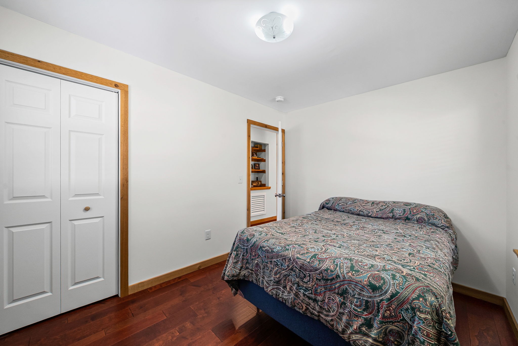 959 Herman Adams Road Cumberland City, TN 37050 - Photo 23 of 62 a bedroom with a bed and wooden floor