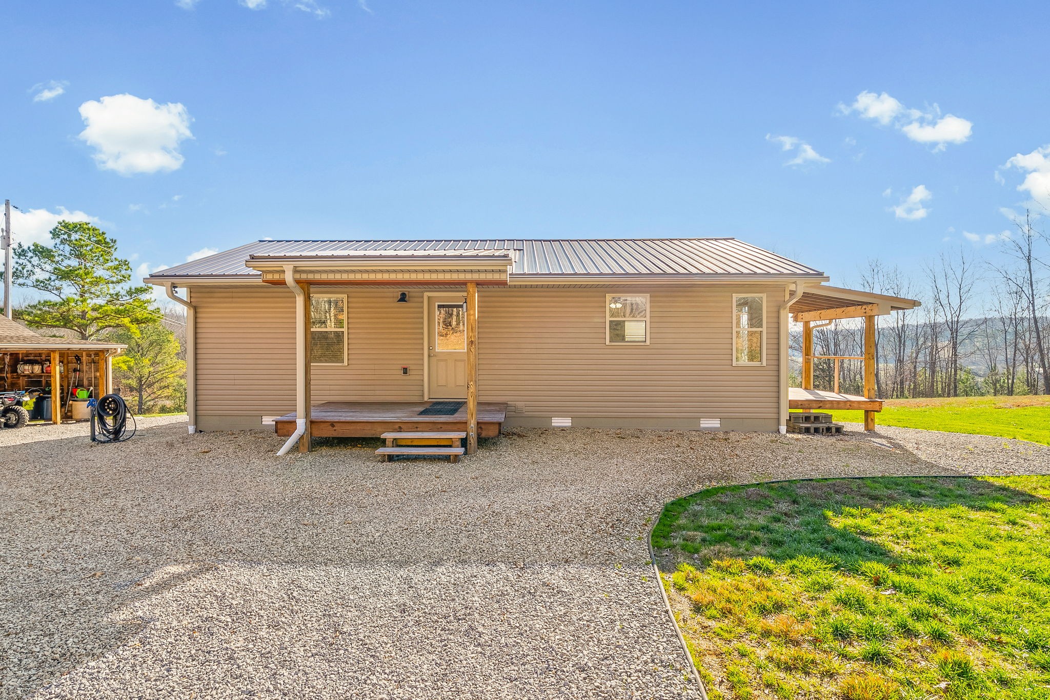 959 Herman Adams Road Cumberland City, TN 37050 - Photo 30 of 62 a view of a house with backyard and sitting area
