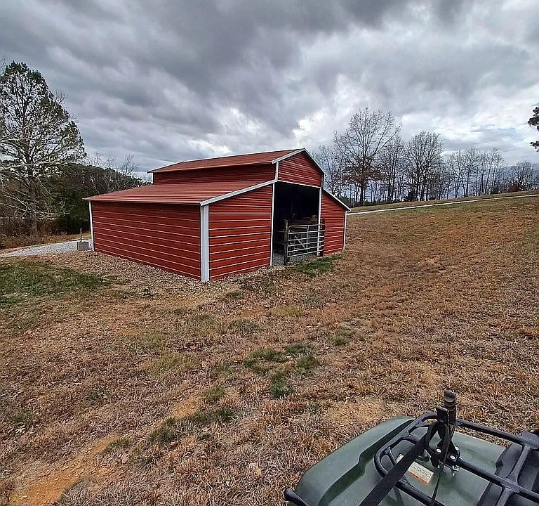 959 Herman Adams Road Cumberland City, TN 37050 - Photo 39 of 62 a backyard of a house with lots of green space