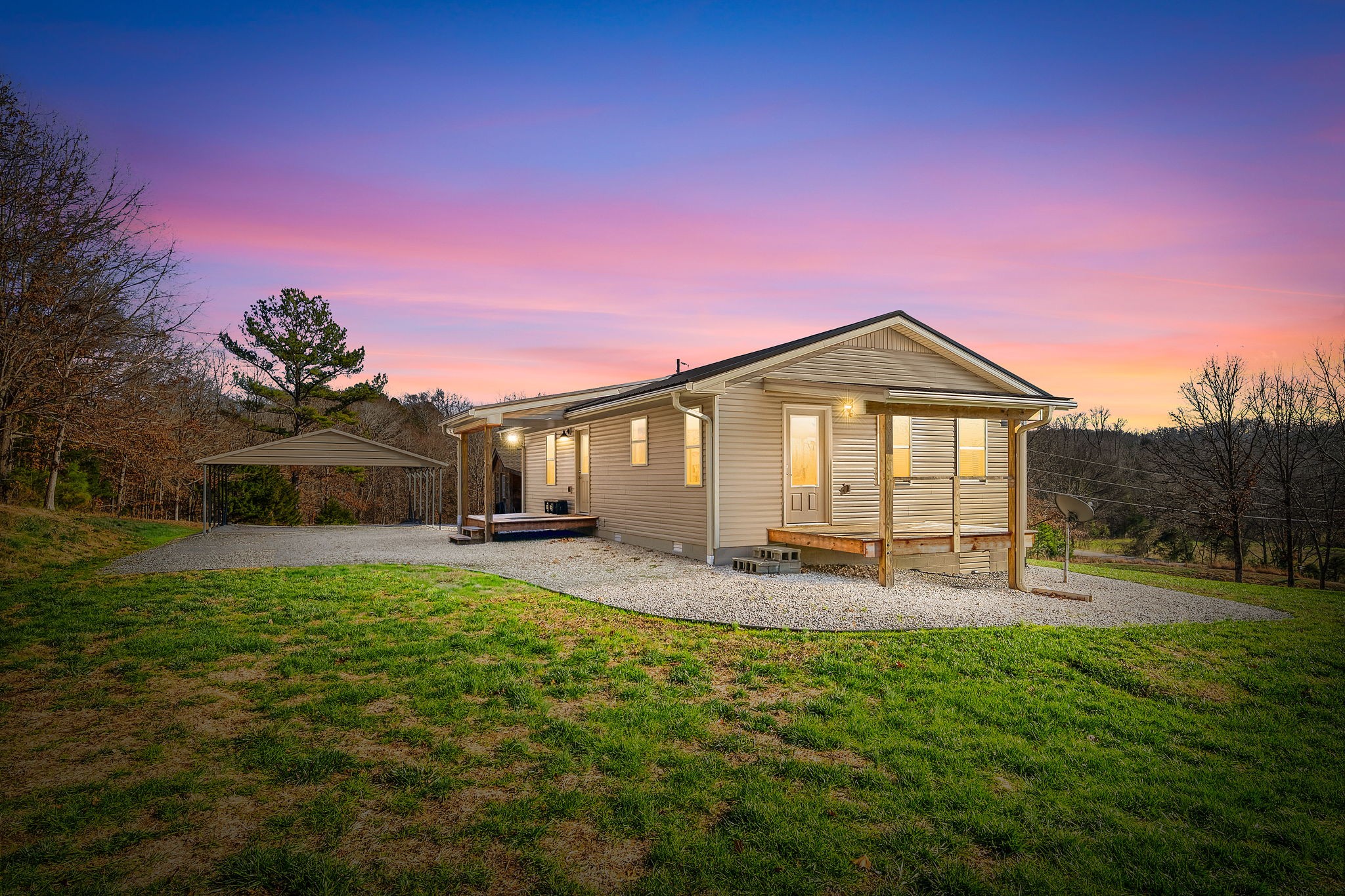 959 Herman Adams Road Cumberland City, TN 37050 - Photo 4 of 62 a front view of a house with a yard and garage