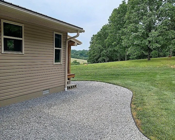 959 Herman Adams Road Cumberland City, TN 37050 - Photo 45 of 62 a view of a house with a backyard