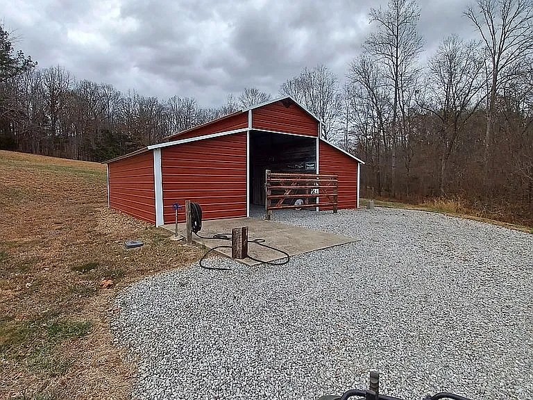 959 Herman Adams Road Cumberland City, TN 37050 - Photo 46 of 62 a backyard of a house with barbeque oven and yard