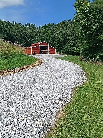 959 Herman Adams Road Cumberland City, TN 37050 - Photo 55 of 62 a house view with a garden space