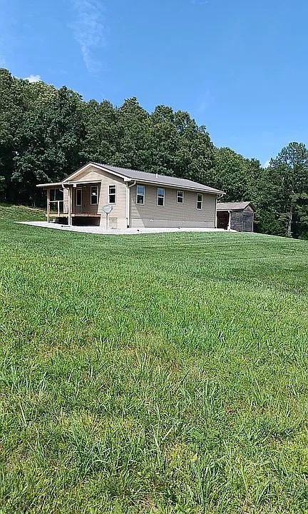 959 Herman Adams Road Cumberland City, TN 37050 - Photo 59 of 62 a view of a house with a backyard