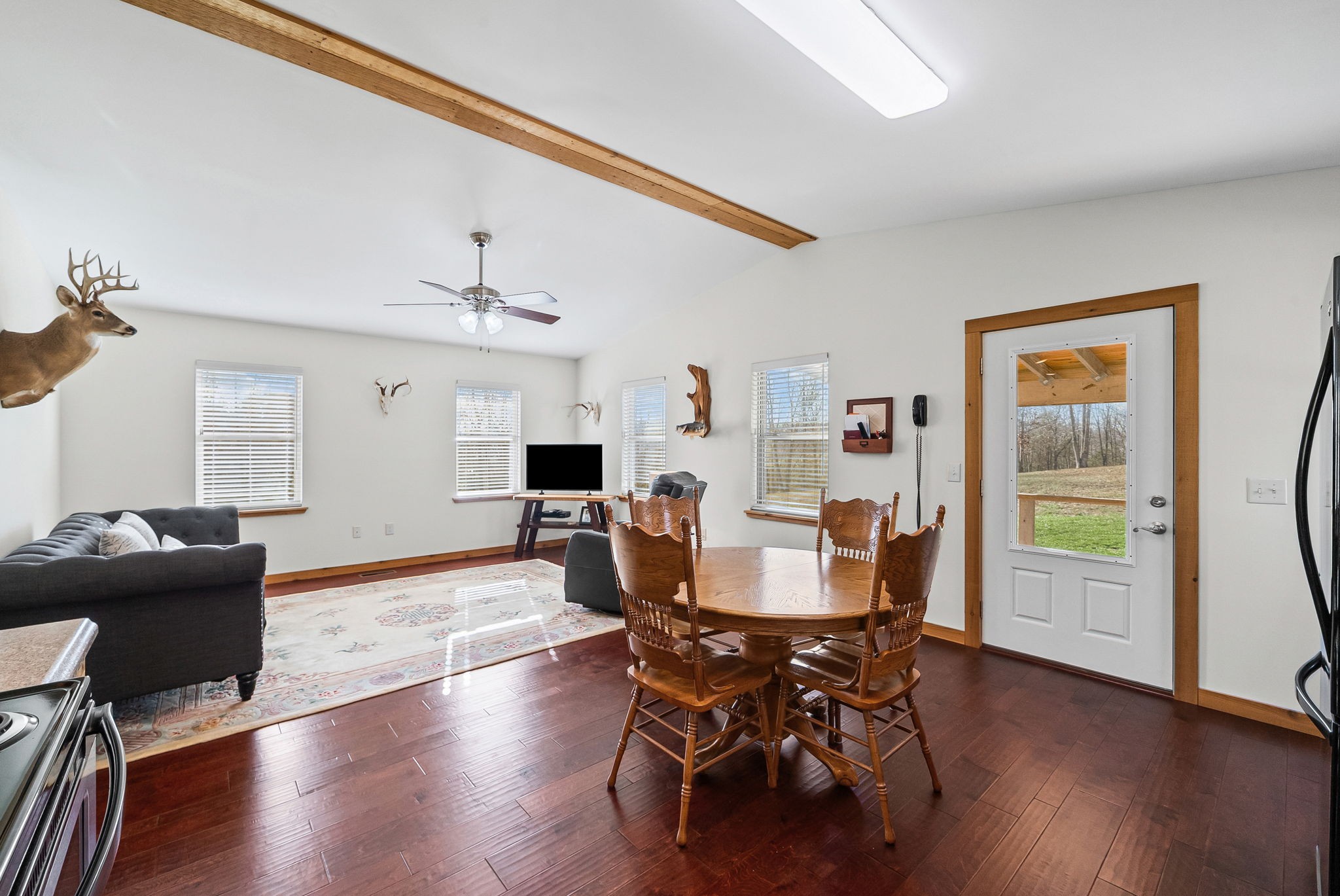 959 Herman Adams Road Cumberland City, TN 37050 - Photo 10 of 62 a view of a dining room with furniture and wooden floor
