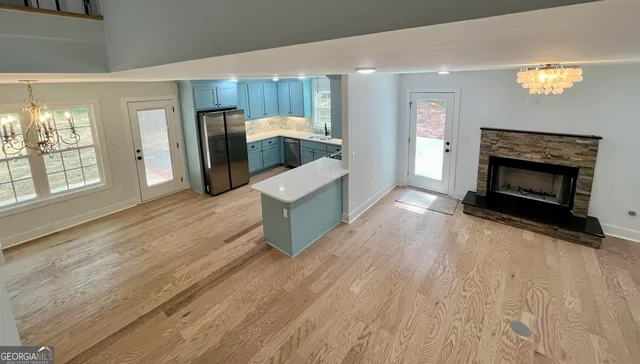 a view of empty room with wooden floor and window
