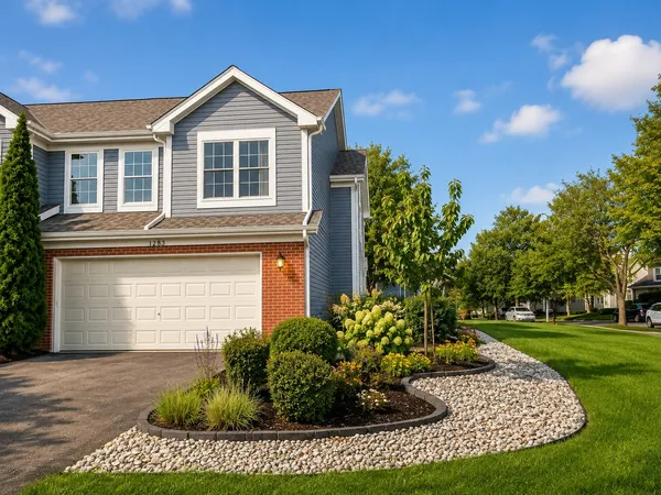 a front view of a house with a yard garage and outdoor seating