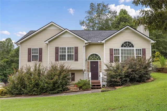 a front view of house with yard and green space