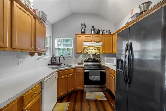 a kitchen with stainless steel appliances a sink stove and refrigerator