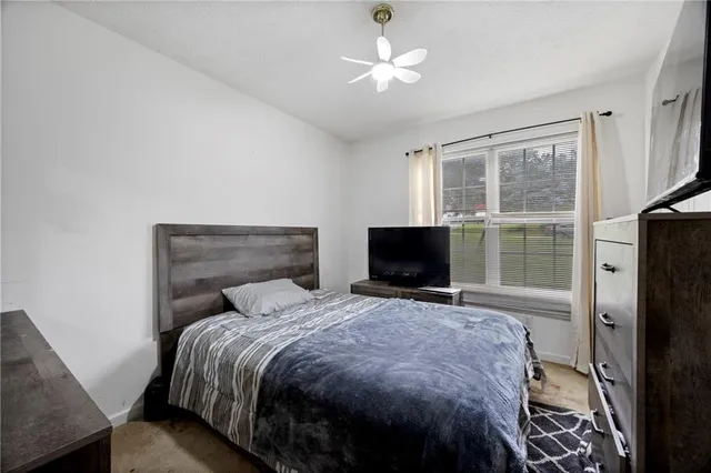 a bedroom with a bed and a television