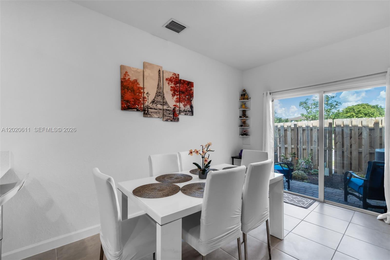 26455 Southwest 148th Avenue Homestead, FL 33032 - Photo 9 of 35 a view of a dining room that has a table and a chair in it