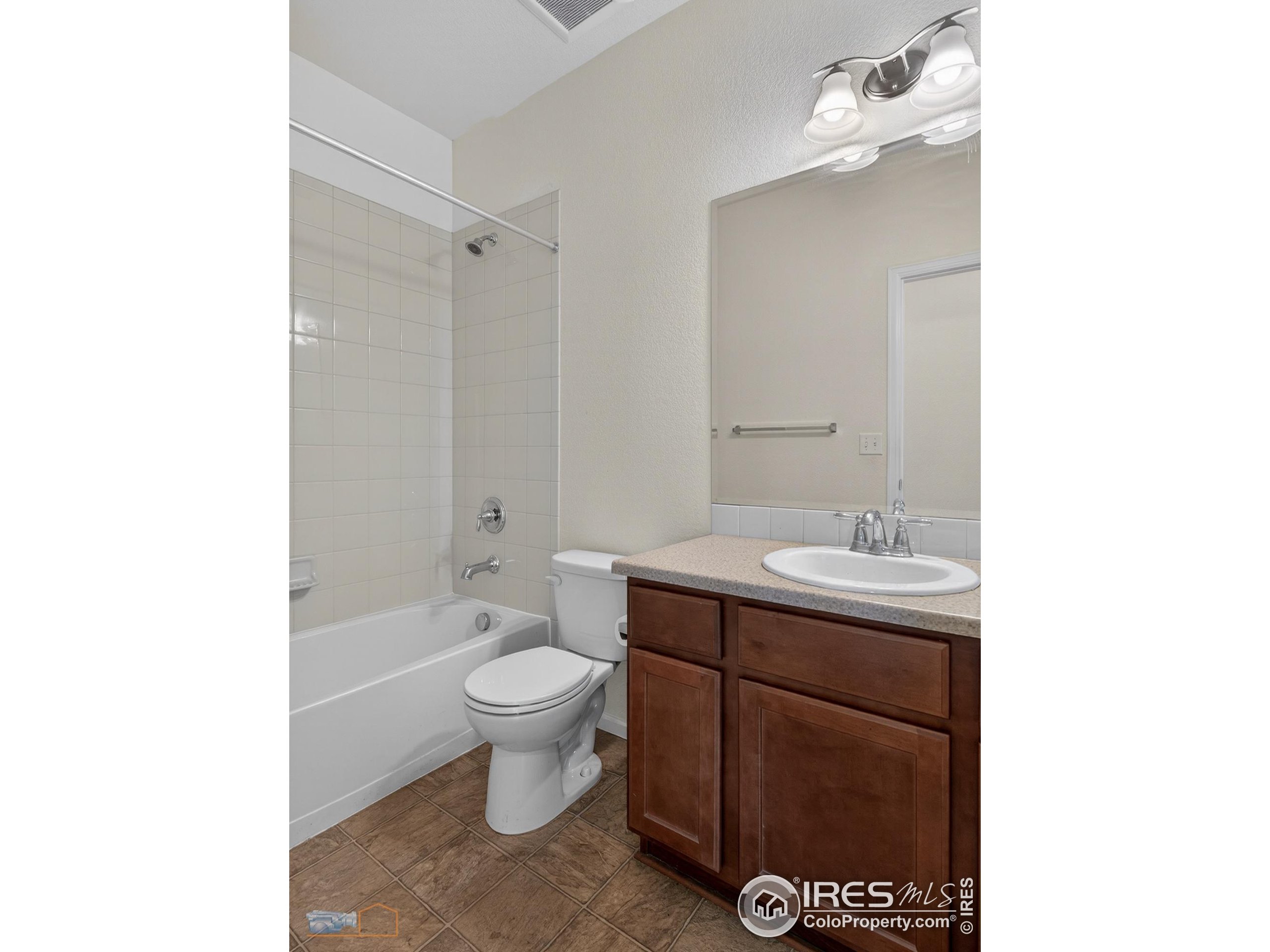 1435 Rustic Drive Longmont, CO 80504 - Photo 20 of 45 a bathroom with a sink a toilet and shower