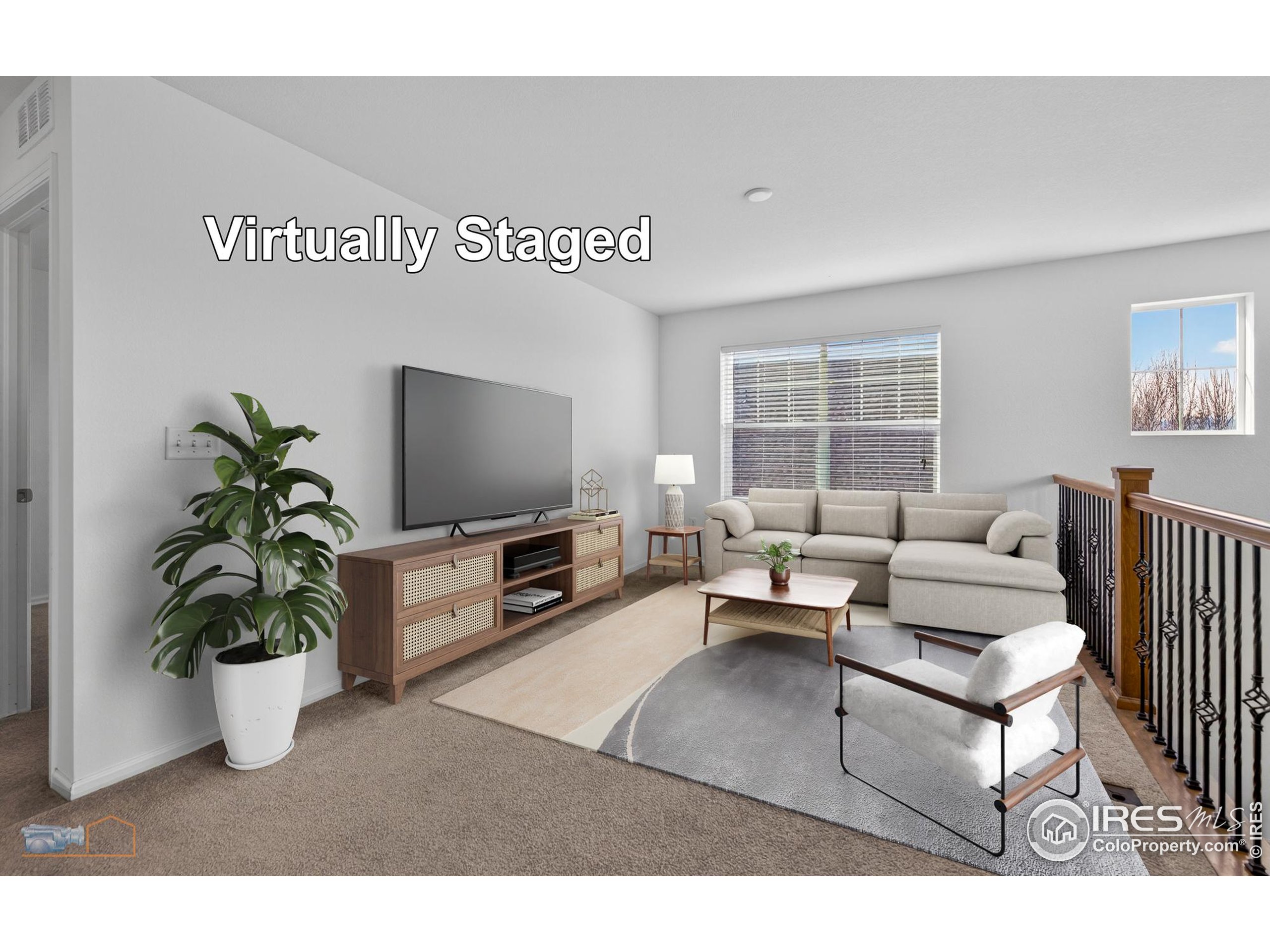 1435 Rustic Drive Longmont, CO 80504 - Photo 23 of 45 a living room with furniture and a flat screen tv