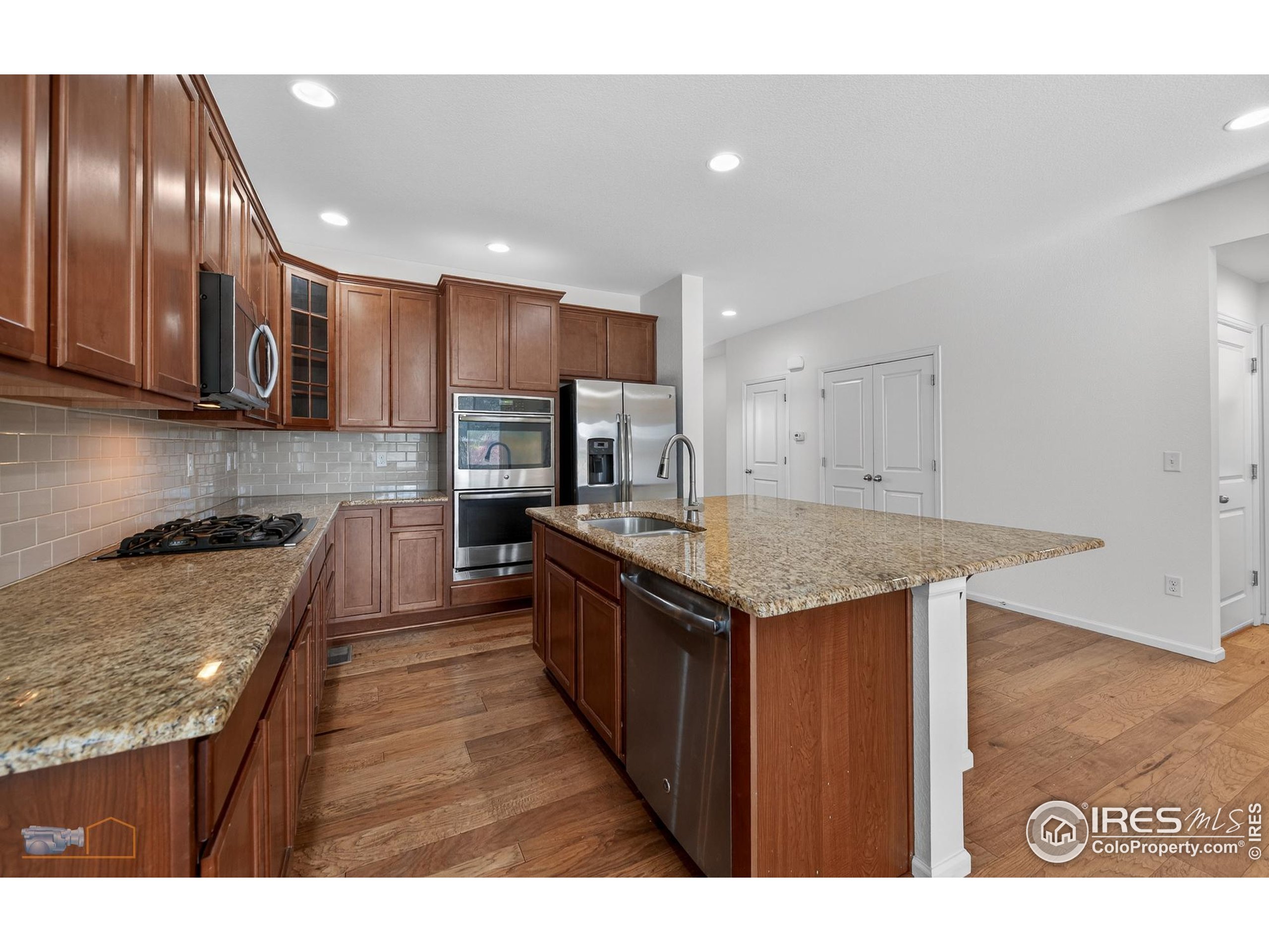 1435 Rustic Drive Longmont, CO 80504 - Photo 9 of 45 a kitchen with stainless steel appliances granite countertop a stove a sink and a refrigerator